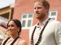 Duke of Sussex Prince Harry (R) his wife Meghan Markle (L), Duchess of Sussex, visit the Lightway Academy in Abuja, Nigeria.