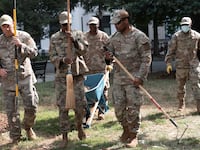 WASHINGTON, DC - AUGUST 28: Air National Guard airmen work clearing leaves and debris from McPherson Square Park on August 28, 2025 in Washington, DC. The Trump administration has deployed federal officers and the National Guard to the District in order to place the DC Metropolitan Police Department under federal control and assist in crime prevention in the nation's capital. (Photo by Andrew Leyden/Getty Images)