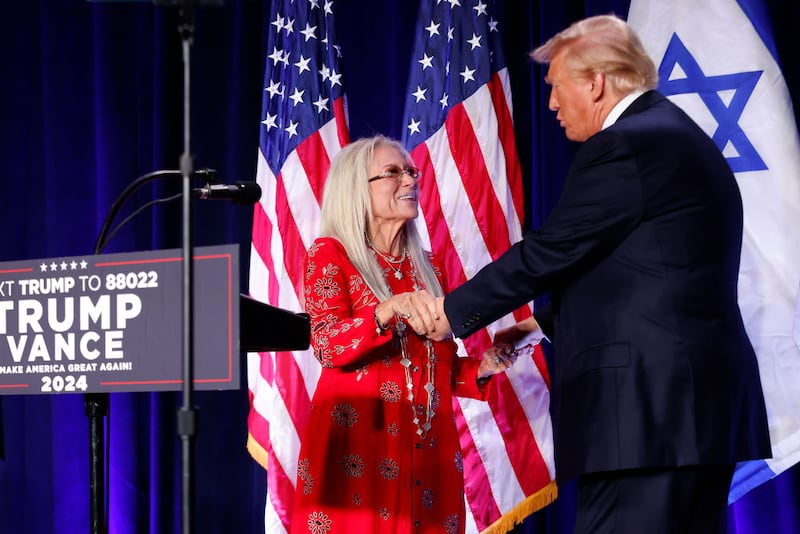 Miriam Adelson, widow of billionaire casino magnate Sheldon Adelson, welcomes Republican presidential nominee, former U.S. President Donald Trump to the stage to speak before prominent Jewish donors at an event titled "Fighting Anti-Semitism in America" at the Hyatt Regency Capitol Hill on September 19, 2024 in Washington, DC.