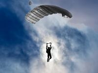 Skydiver and full moon with clouds.