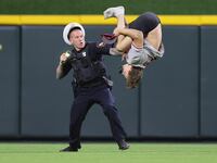 William Hendon does a backflip while a police officer attempts to tase him.