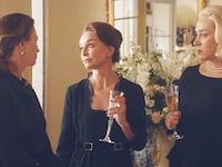 Diane Lane, Calista Flockhart and Chloe Sevigny in black talking to each other in 'Feud: Capote vs the Swans'
