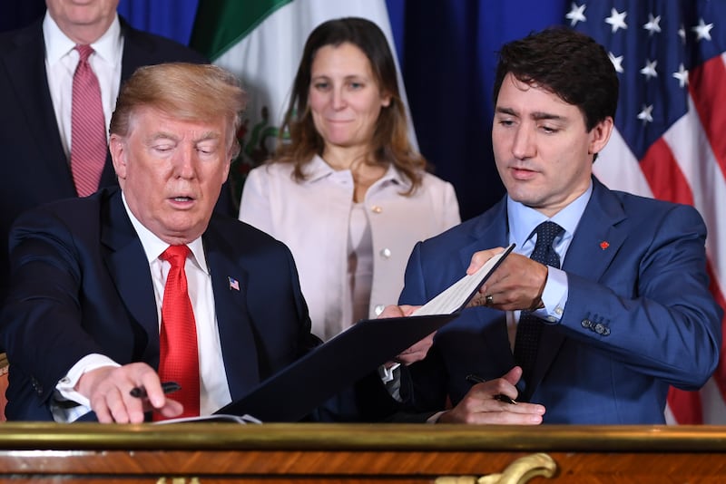 President-elect Donald Trump and Canadian Prime Minister Justin Trudeau sign a new free trade agreement as former Canadian Finance Minister Chrystia Freeland looks on in Buenos Aires, on November 30, 2018.