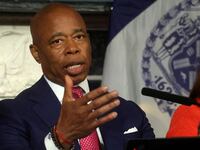 Eric Adams, wearing a suit and tie, speaks during a press conference.