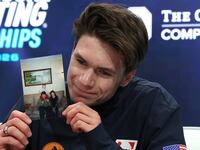 ST LOUIS, MISSOURI - JANUARY 10: Maxim Naumov holds a photograph of his parents in the kiss & cry after competing in the Championship Men Free Skating during the 2026 United States Figure Skating Championships at Enterprise Center on January 10, 2026 in St Louis, Missouri. (Photo by Jamie Squire/Getty Images)