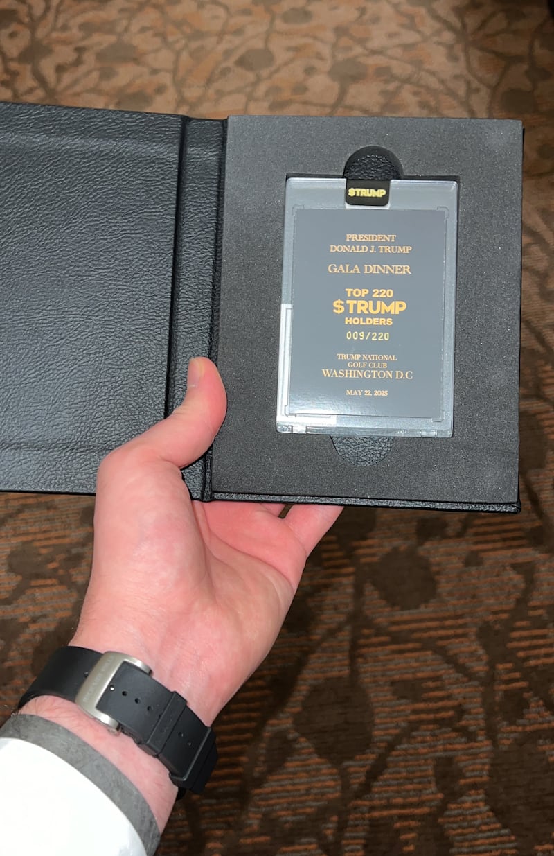 Nick Pinto shows a gift from the $TRUMP meme coin gala dinner.