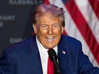 Donald Trump speaks on stage at a campaign event.