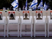A dinner table is set with empty chairs that symbolically represent hostages and missing people with families that are waiting for them to come home, in Tel Aviv, Israel, Oct. 20, 2023.