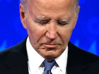US President Joe Biden looks down as he participates in the first presidential debate of the 2024 elections