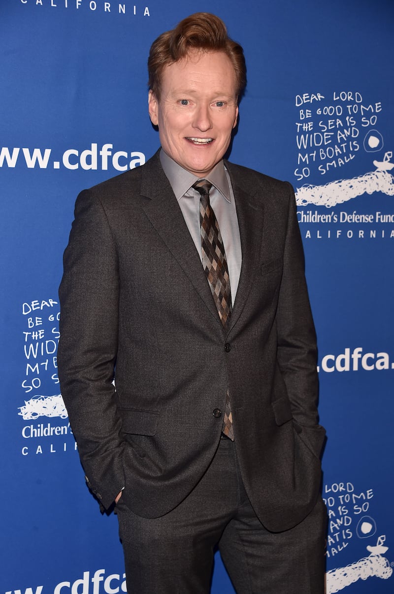 Host Conan O'Brien attends an event in 2026 in Beverly Hills, California, where he wore his usual pompadour and gray suit.