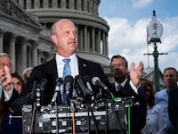 Kevin Roberts, president of The Heritage Foundation, speaks with members of the conservative House Freedom Caucus during a news conference on Capitol Hill.