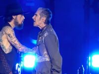 Jane’s Addiction frontman Perry Farrell punches guitarist Dave Navarro at their Boston concert.