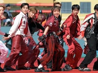 Members of the South Korean boy band BTS perform during the 2026 World Cup football tournament final match between Spain and Argentina.