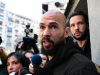 British-US former professional kickboxer and controversial influencer Andrew Tate (front) and his brother Tristan Tate (back R) speak to journalists after having been released from detention in Bucharest, Romania.