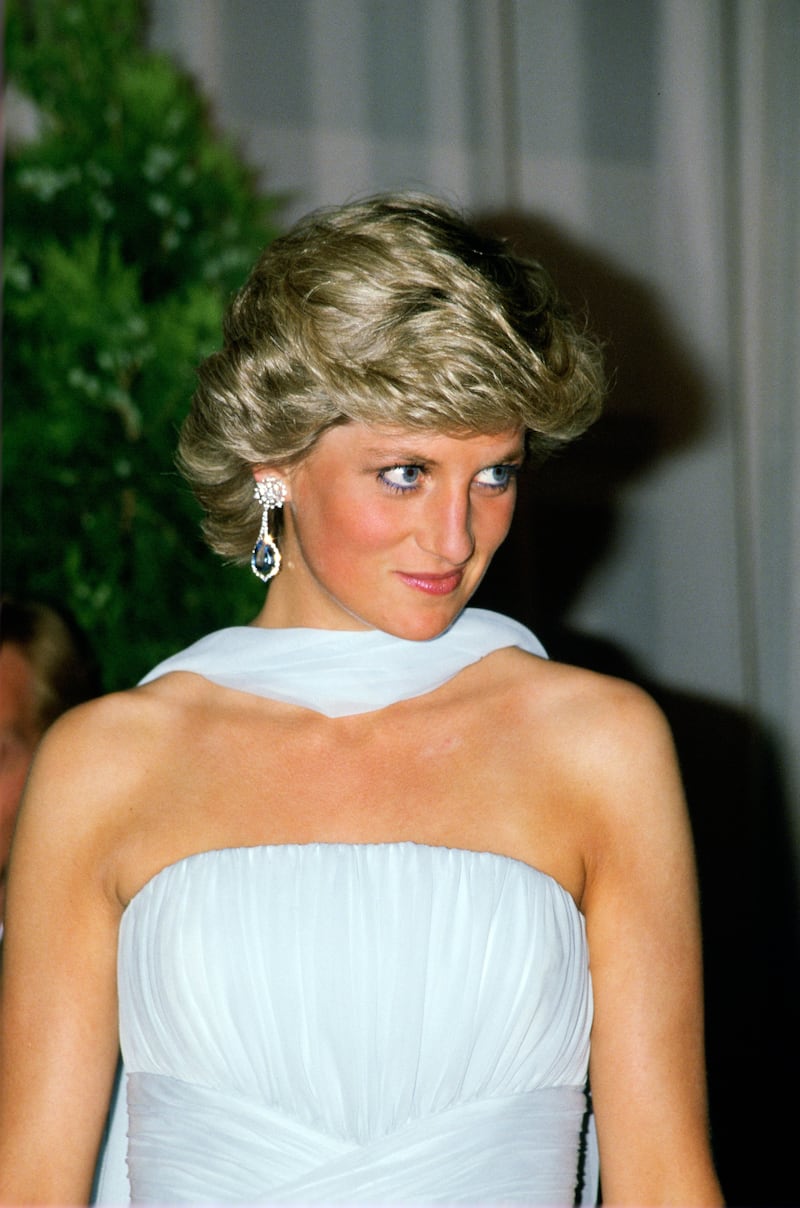 Diana, Princess of Wales, accessorized her Cannes look with bejeweled chandelier earrings.