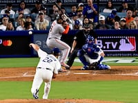 Clayton Kershaw #22 of the Los Angeles Dodgers strikes out Rafael Devers #16 of the San Francisco Giants.