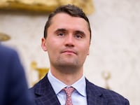 WASHINGTON, DC - MAY 28: Turning Point USA co-founder Charlie Kirk stands in the back of the room as U.S. President Donald Trump speaks during a swearing in ceremony for interim U.S. Attorney for Washington, D.C. Jeanine Pirro in the Oval Office of the White House on May 28, 2025 in Washington, DC. Trump has announced Pirro, a former Fox News personality, judge, prosecutor, and politician, after losing support in the Senate for his first choice, Ed Martin, over his views on the January 6, 2021 attack on the U.S. Capitol.