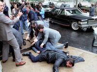 White House Press Secretary James Brady and District of Columbia police officer Thomas Delahanty lie wounded on the ground after John Hinckley Jr. fired six shots at President Ronald Reagan