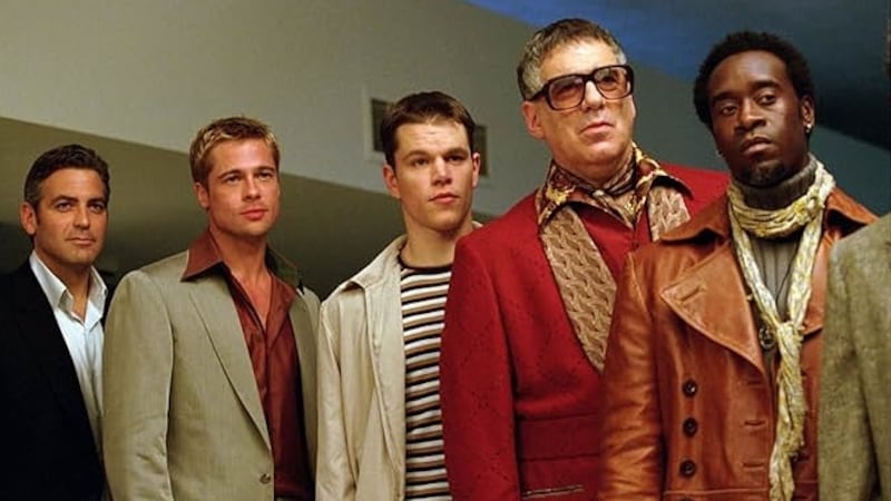 Matt Damon and Brad Pitt appear in a scene from the 2001 film ‘Oceans 11’ with cast members George Clooney, Don Cheadle, and Elliott Gould.