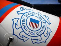 U.S. Coast Guard's logo is seen on a helicopter on the deck