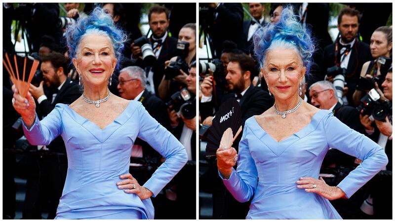 Helen Mirren is pictured wearing a purple dress with a matching purple and blue updo upon her arrival at the 2023 Cannes Film Festival in Cannes, France.