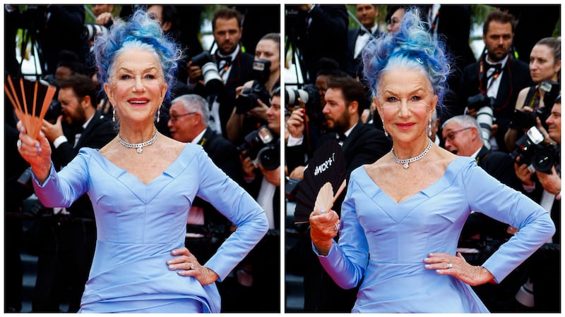 Helen Mirren is pictured wearing a purple dress with a matching purple and blue updo upon her arrival at the 2023 Cannes Film Festival in Cannes, France.