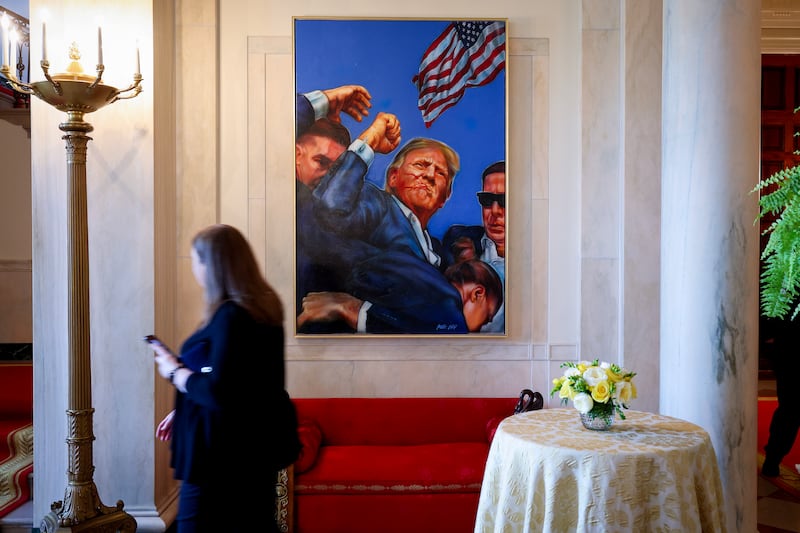 WASHINGTON, DC - APRIL 15: A painting depicting the Associated Press photograph of the aftermath of the assassination attempt on then U.S. Presidential candidate Donald Trump in Butler, Pennsylvania hangs in the Entrance Hall of the White House on April 15, 2025 in Washington, DC. The painting has recently replaced the White House portrait of former U.S. President Barack Obama. (Photo by Win McNamee/Getty Images)