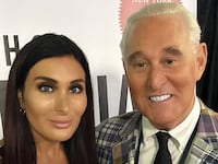 Laura Loomer and Roger Stone pose for a photo together.