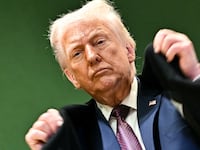 President Donald Trump adjusts his jacket as he leaves the Congress Centre during the World Economic Forum (WEF) annual meeting in Davos on January 22, 2026.