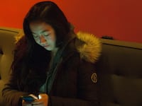 Girl Looking at iPhone.