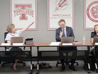 Tipp City School Board member Anne Zakkour gives a Nazi salute to president Simon Patry.