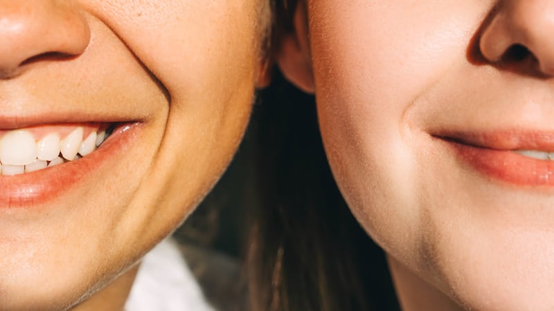 Two young beautiful smiling women close-up