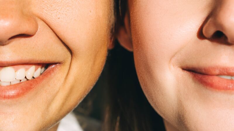 Two young beautiful smiling women close-up