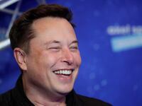 Elon Musk laughs