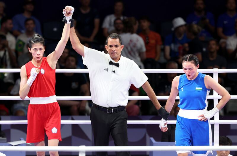 Taipei's Yu Ting Lin, red, raises her arm in victory as Uzebekistan's Sitora Turdibekova looks away at the 2024 Paris Olympics.
