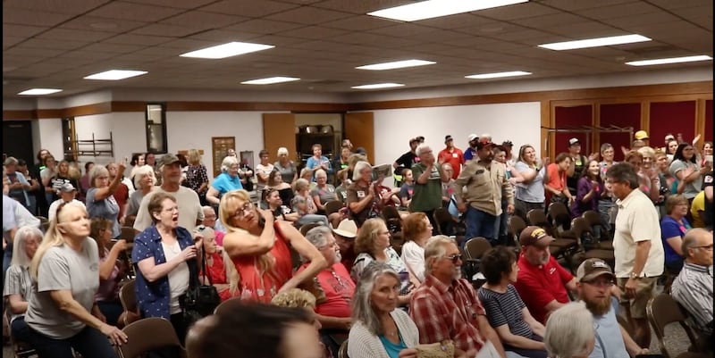The crowd reacts after a July 28 meeting of the Campbell County Library Board ousted Terri Lesley.