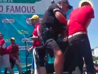 articles/2016/07/05/watch-protesters-dump-fake-blood-on-hot-dog-eating-contestants/160705-Place-nathans-hot-dog-protest-fake-blood-Tease_pl3ynx
