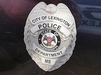 A police shield is displayed on a Lexington, Mississippi police cruiser