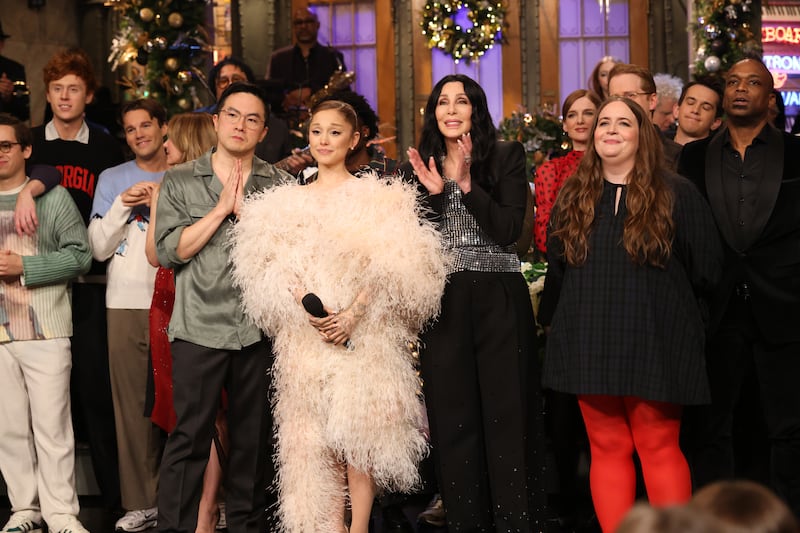 SATURDAY NIGHT LIVE -- Episode 1893 -- Pictured: (l-r) Bowen Yang, host Ariana Grande, musical guest Cher, surprise guest Aidy Bryant, and guitarist Kirk Douglas during Goodnights & Credits on Saturday, December 20, 2025 -- (Photo by: Will Heath/NBC via Getty Images)
