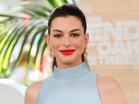 Anne Hathaway wears blue halter top and red lipstick to attend the world premiere of Warner Bros.' "The End Of Oak Street" at Warner Bros. Studios on August 9, 2026, in Burbank, California.