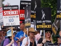 SAG-AFTRA actors and Writers Guild of America (WGA) writers walk a picket line in Los Angeles, California. Universal Pictures has been accused of trimming trees that shaded SAG-AFTRA and WGA strikers from the sweltering heat.