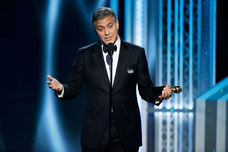 articles/2015/01/11/golden-globes-2015-a-fun-sweaty-and-serious-affair-boasting-cosby-jokes-and-je-suis-charlie/150111-george-clooney-stern-tease_x8a1qp