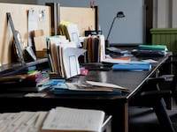 An empty office desk full of items and files
