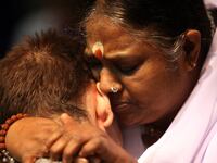 articles/2014/07/20/patted-down-by-india-s-hugging-saint/140718-genis-hug-tease_cvkx68