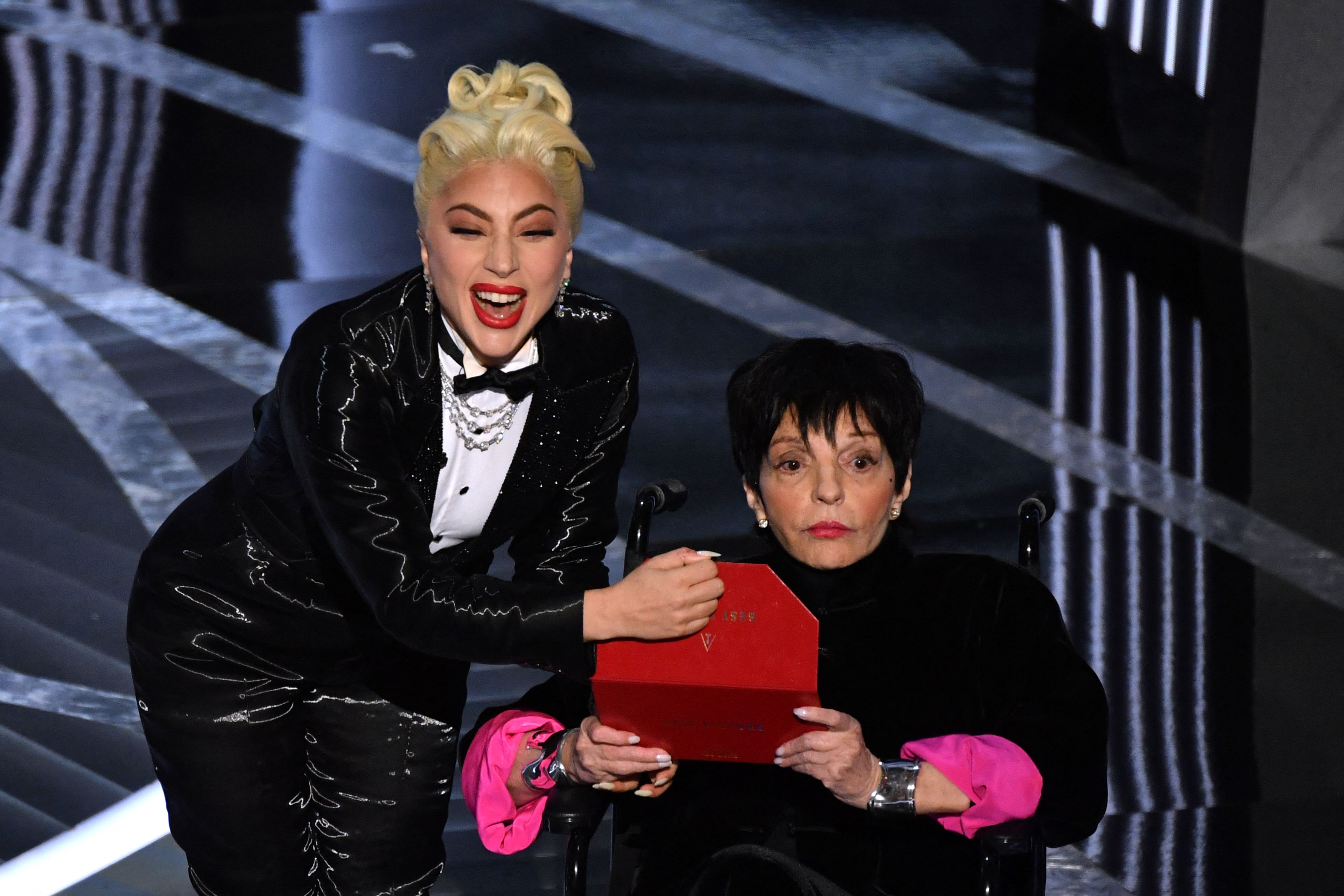 TOPSHOT - US actress-singer Lady Gaga (L) and US actress Liza Minnelli announce the Best Picture award onstage during the 94th Oscars at the Dolby Theatre in Hollywood, California on March 27, 2022.