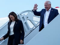 Vice President Kamala Harris and Minnesota Gov. Tim Walz walk down the steps from Air Force Two at Hilton Head International Airport in Savannah, Georgia.