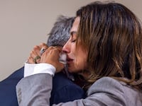 Actor Alec Baldwin and his wife, Hilaria, hug following the dismissal