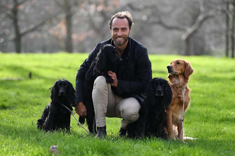 James Middleton poses for a photograph with his dogs Inka, Luna, Ella and Mabel.