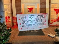 A banner hangs outside the home of Brooklyn Museum director Anne Pasternak.