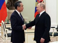 Russia's President Vladimir Putin shakes hands with China's Director of the Office of the Central Foreign Affairs Commission Wang Yi during a meeting in Moscow, Russia February 22, 2023.